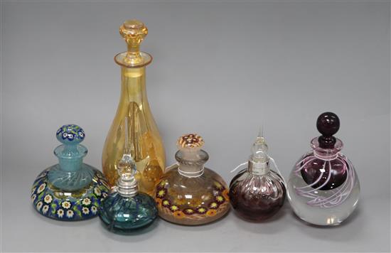 Two millefiore glass paperweight inkwells, three coloured glass scent flasks (two silver-mounted) and an amber glass carafe